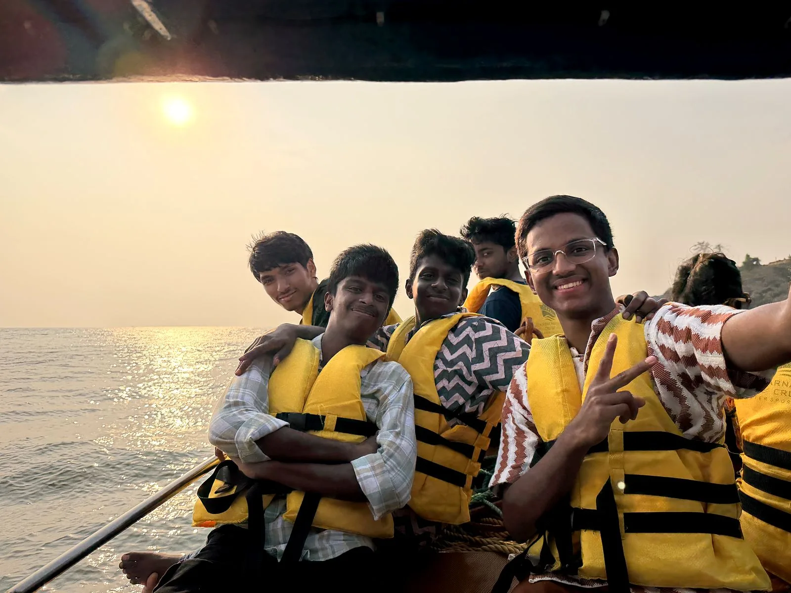 Friends on the boat at sunset