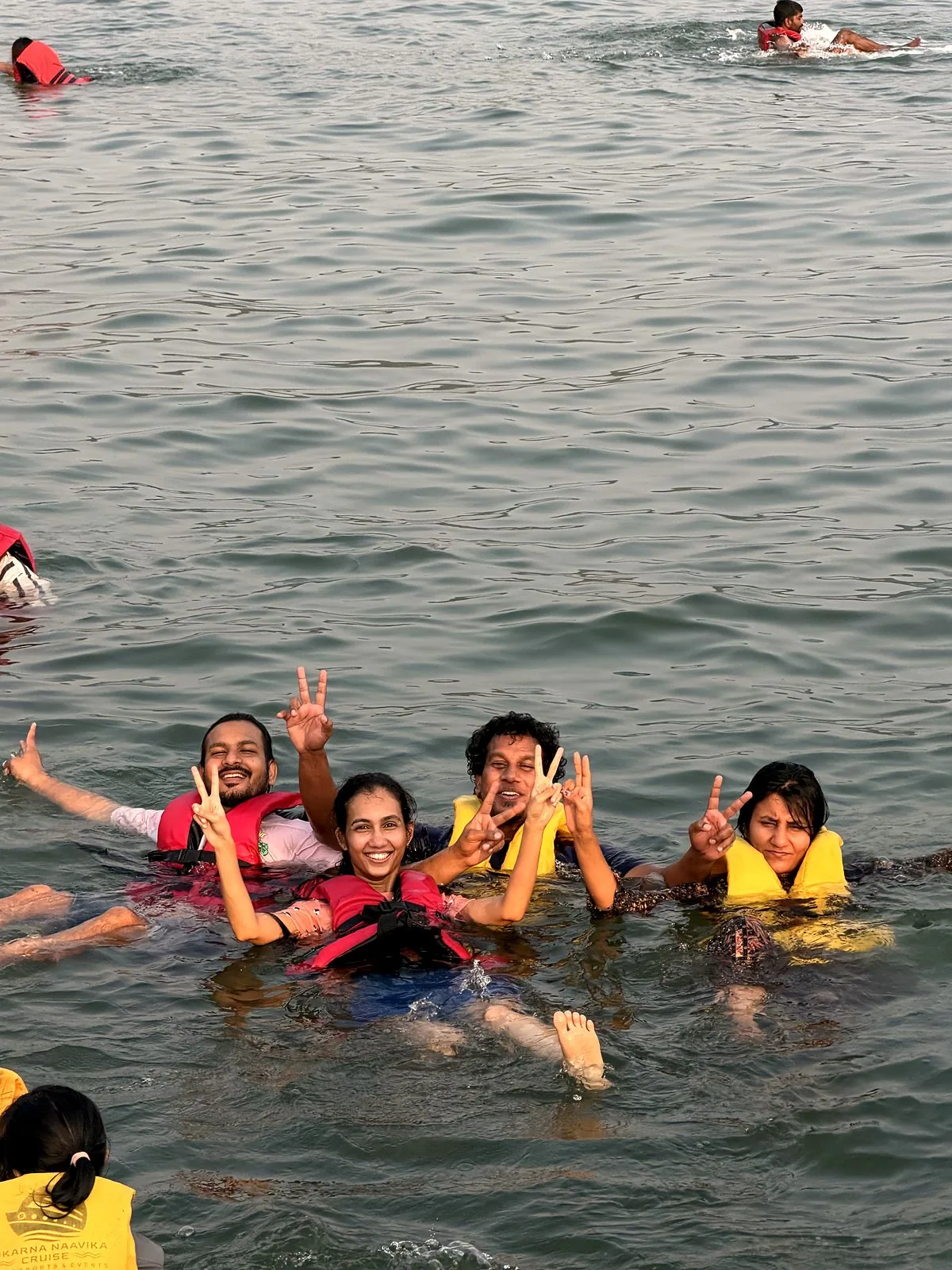Guests swimming and waving in the sea