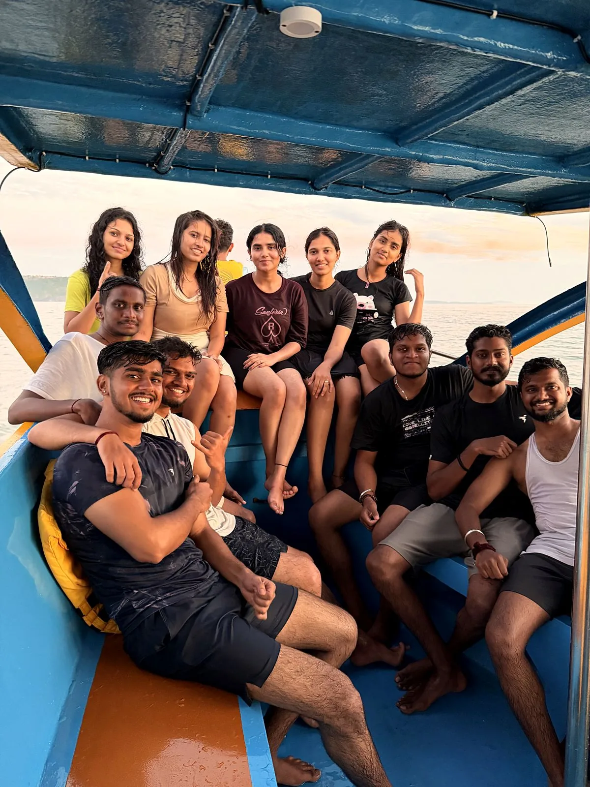 Group of friends inside the Naavika boat